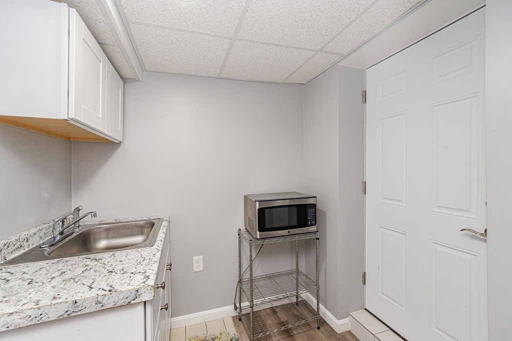 2 Lorenzo Road Lawrence, MA 01843 - Photo 29 of 42 a kitchen with a sink and a stove top oven
