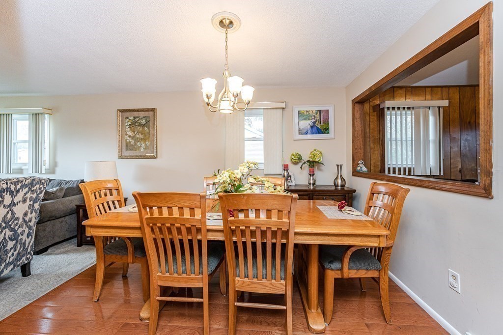 2 Lorenzo Road Lawrence, MA 01843 - Photo 10 of 42 a view of a dining room with furniture wooden floor and chandelier