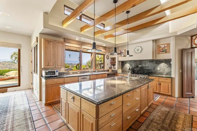 a dining room with furniture a chandelier and wooden floor