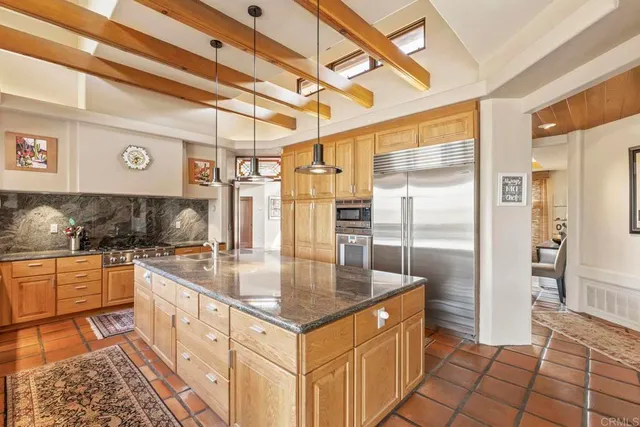 a dining room with furniture a chandelier and wooden floor