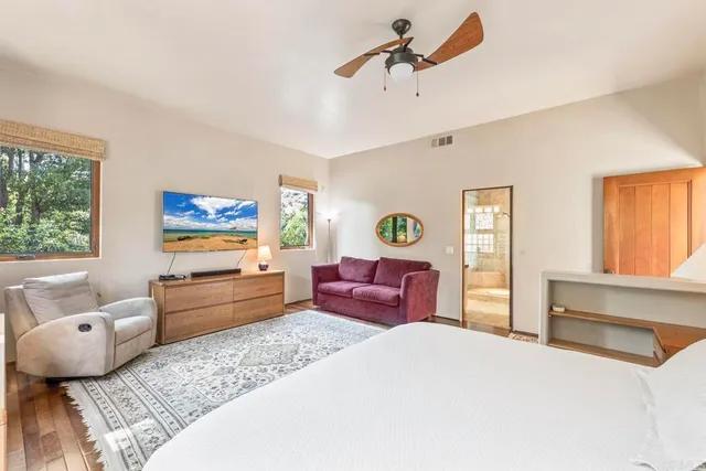 a bathroom with a granite countertop tub sink a mirror a shower and vanity