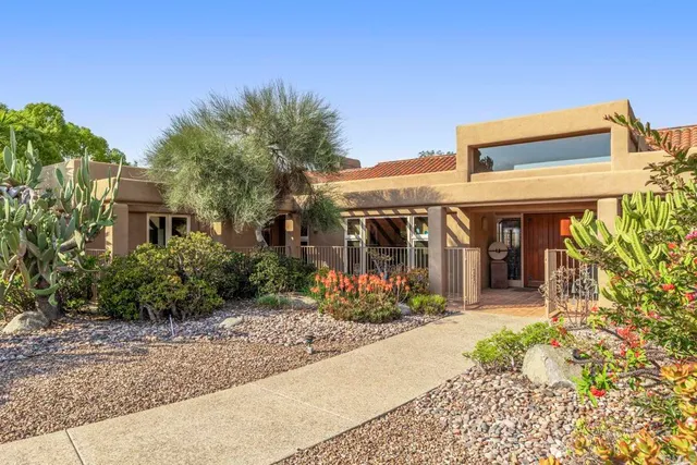 a aerial view of a house with a yard swimming pool and outdoor seating