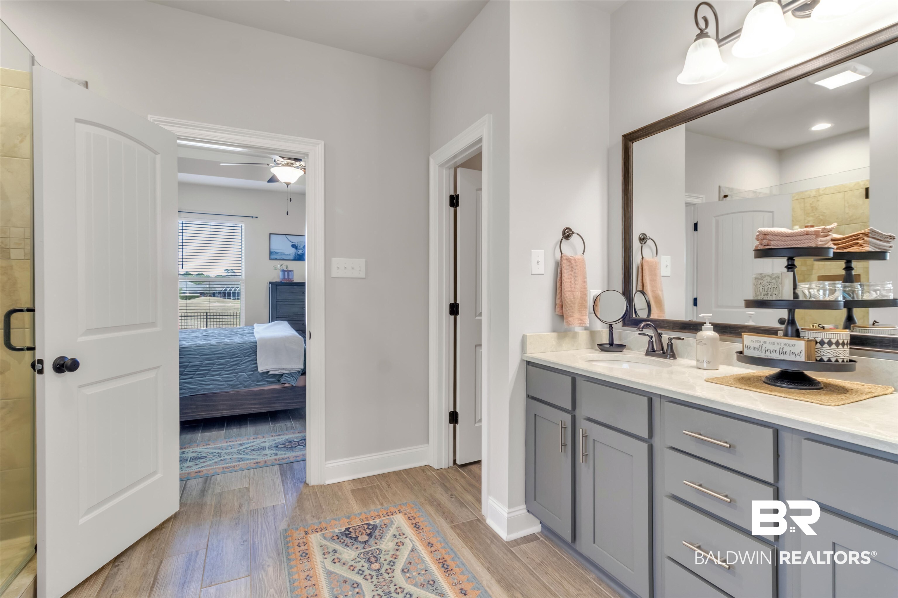 22531 Putter Lane Foley, AL 36535 - Photo 24 of 43 Ensuite bathroom with a shower stall, light wood-type flooring, and vanity