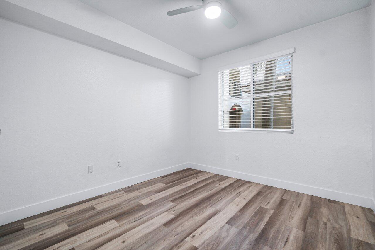 1117 Renaissance Way, Unit 117 Boynton Beach, FL 33426 - Photo 18 of 31 a view of a room with wooden floor and windows