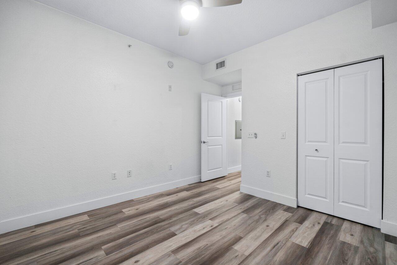 1117 Renaissance Way, Unit 117 Boynton Beach, FL 33426 - Photo 19 of 31 wooden floor in an empty room