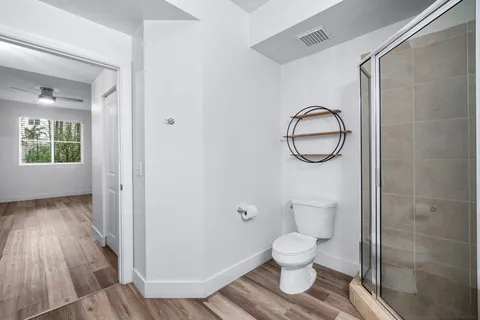 a bathroom with a toilet and a mirror