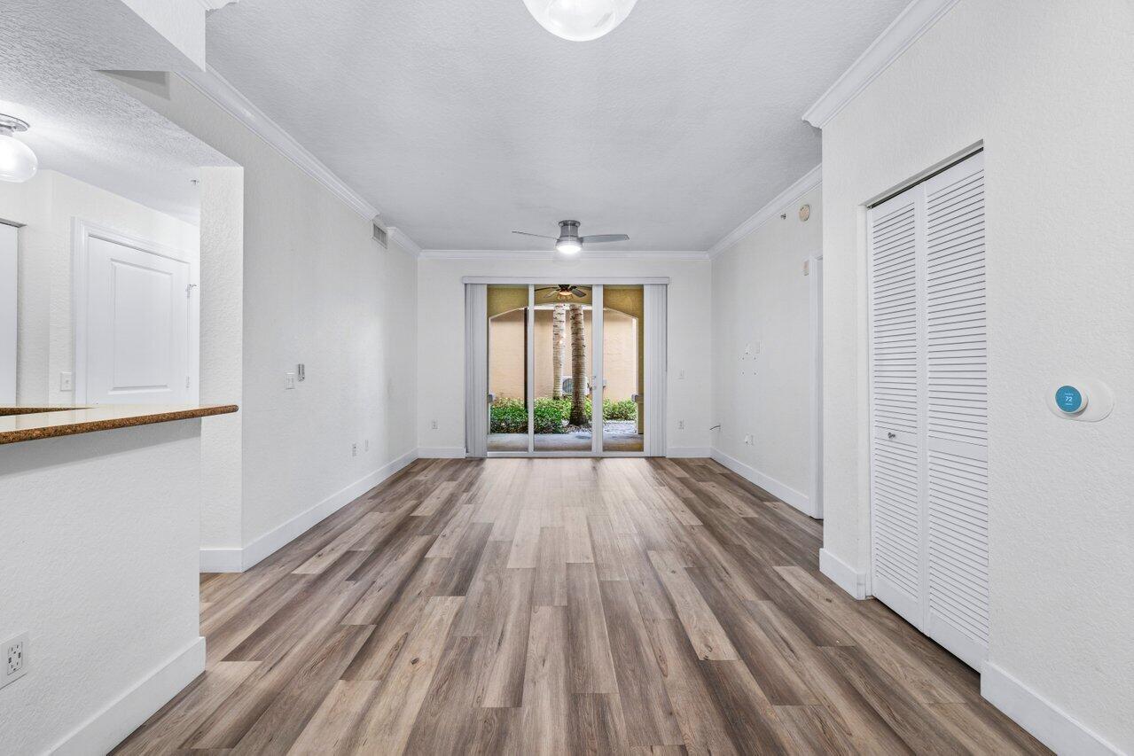 1117 Renaissance Way, Unit 117 Boynton Beach, FL 33426 - Photo 5 of 31 a view of empty room with wooden floor and fan