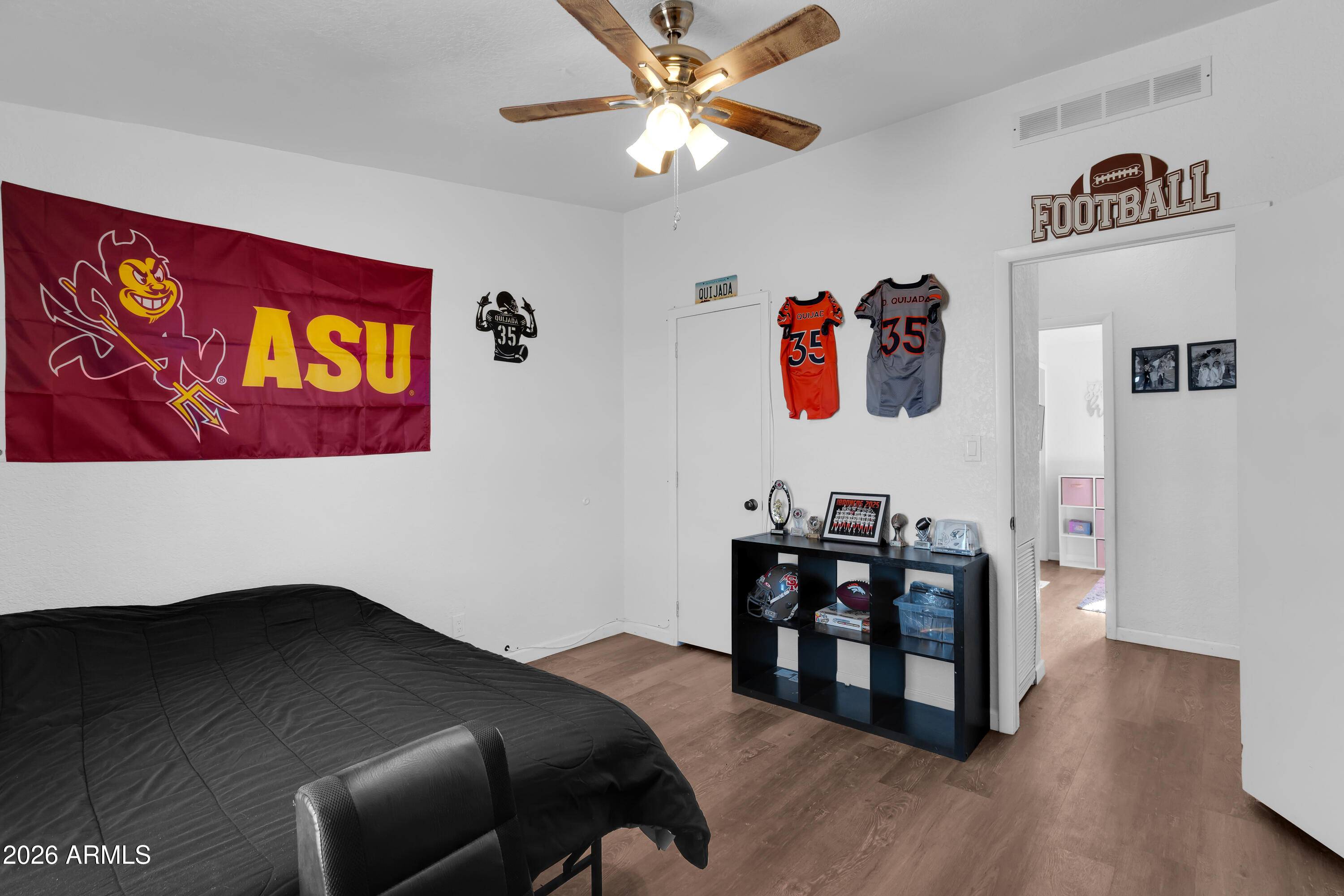 8902 Ghost Ranch Road Marana, AZ 85653 - Photo 16 of 28 a bedroom with a bed and a chandelier