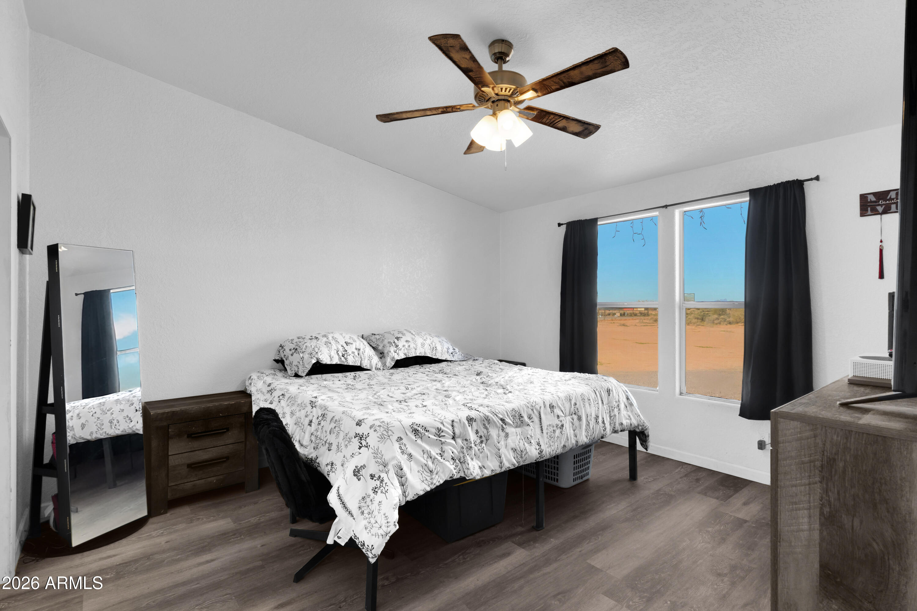 8902 Ghost Ranch Road Marana, AZ 85653 - Photo 17 of 28 a bedroom with a bed a large window with wooden floor