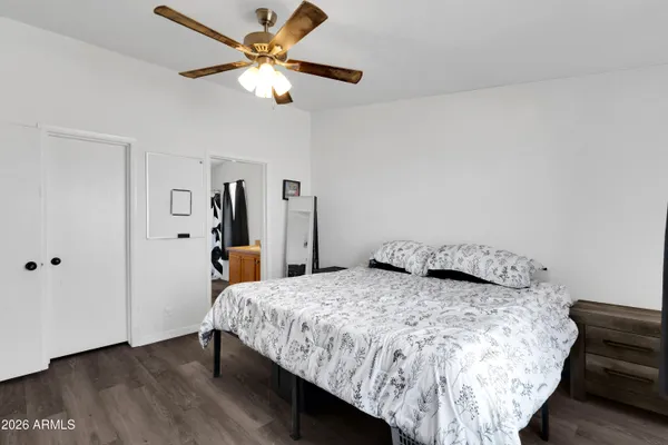 a bedroom with a bed and a chandelier
