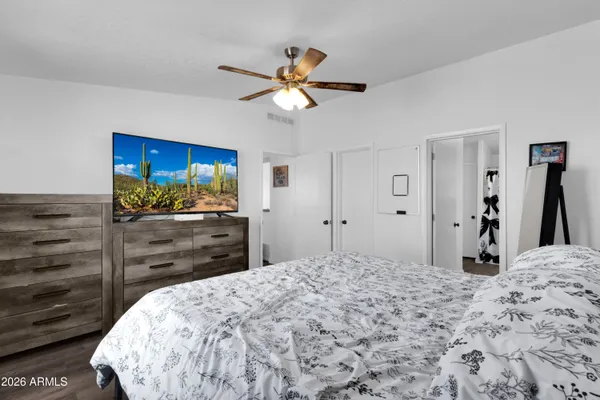 a bedroom with a bed and a flat screen tv