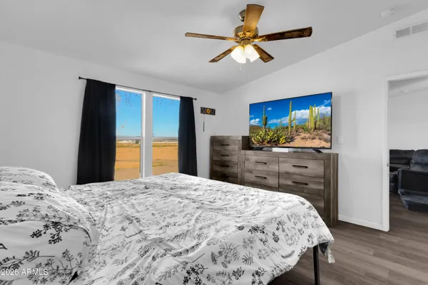 a bedroom with a bed and a flat screen tv