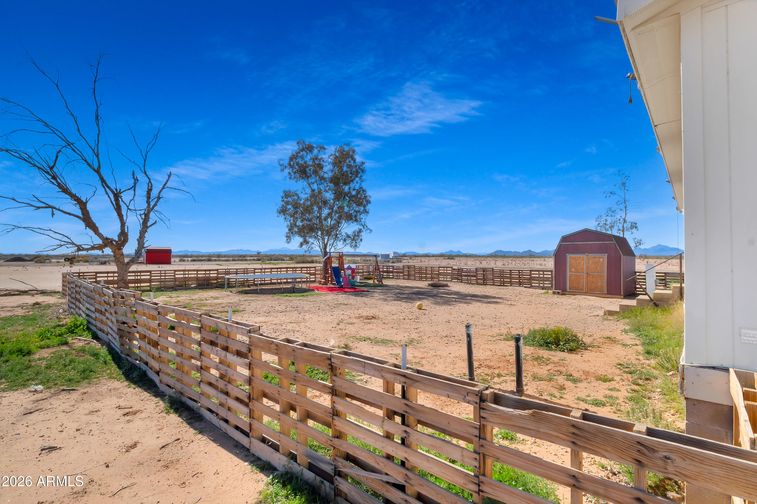 8902 Ghost Ranch Road Marana, AZ 85653 - Photo 2 of 28 a view of a terrace with wooden fence