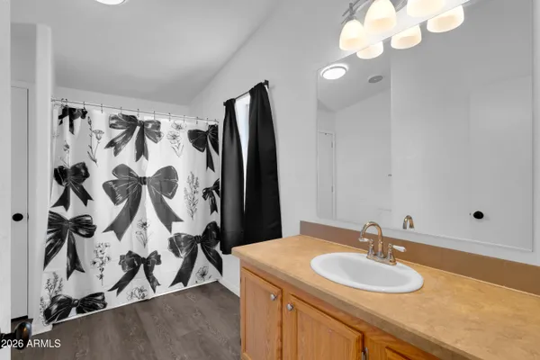 a bathroom with a sink and mirror with toilet