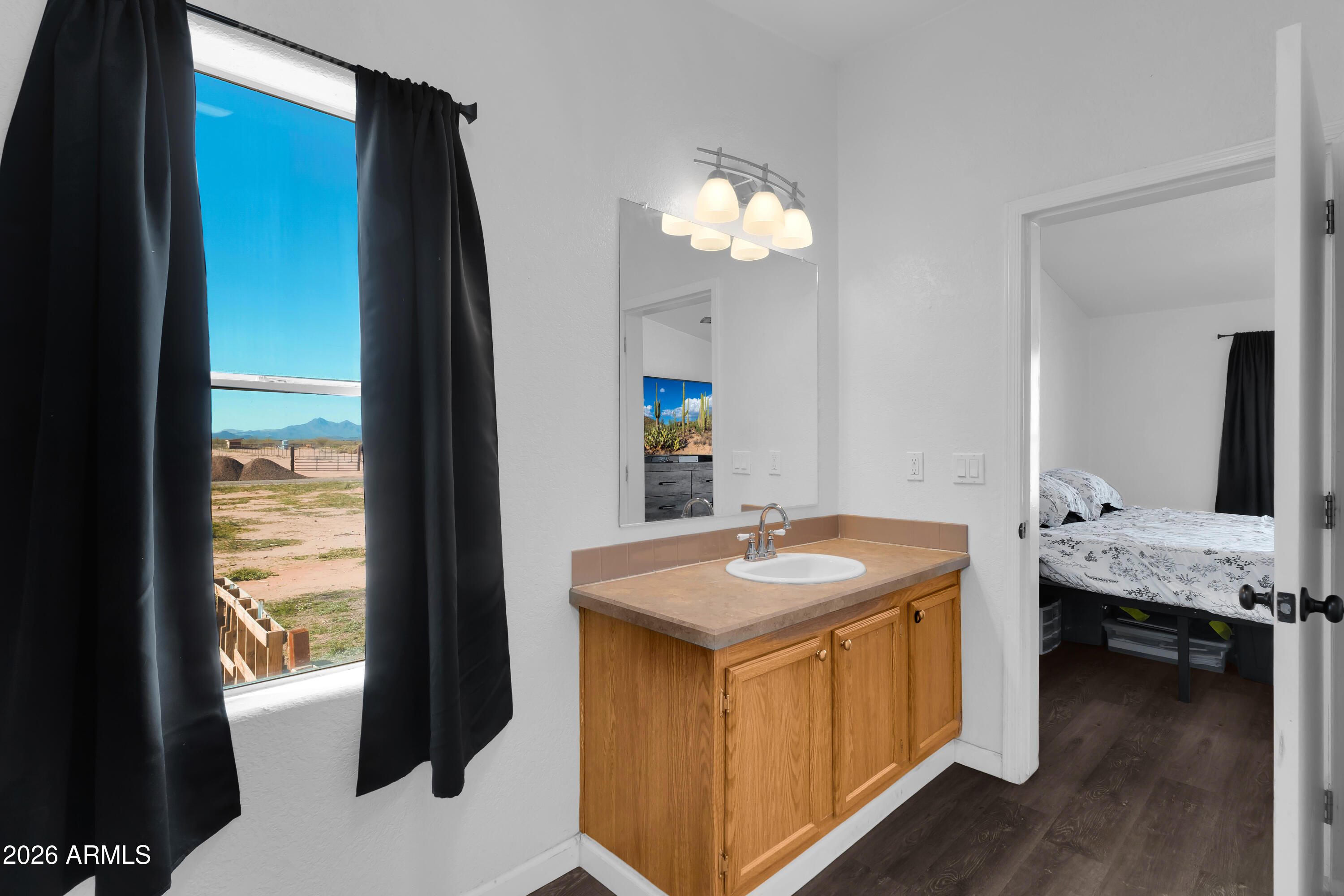 8902 Ghost Ranch Road Marana, AZ 85653 - Photo 22 of 28 a en suite bathroom with a granite countertop sink and a mirror