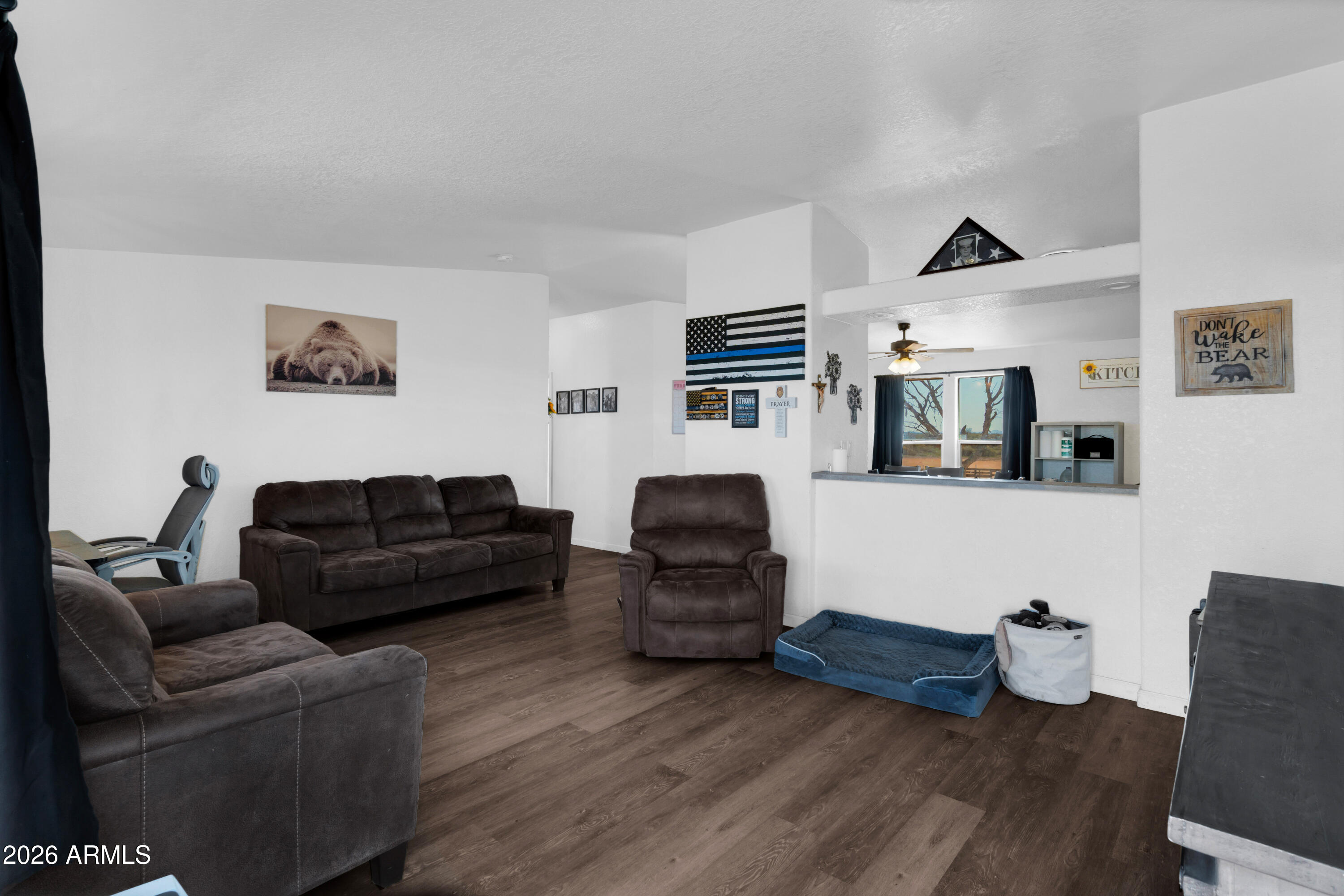 8902 Ghost Ranch Road Marana, AZ 85653 - Photo 3 of 28 a living room with furniture and wooden floor