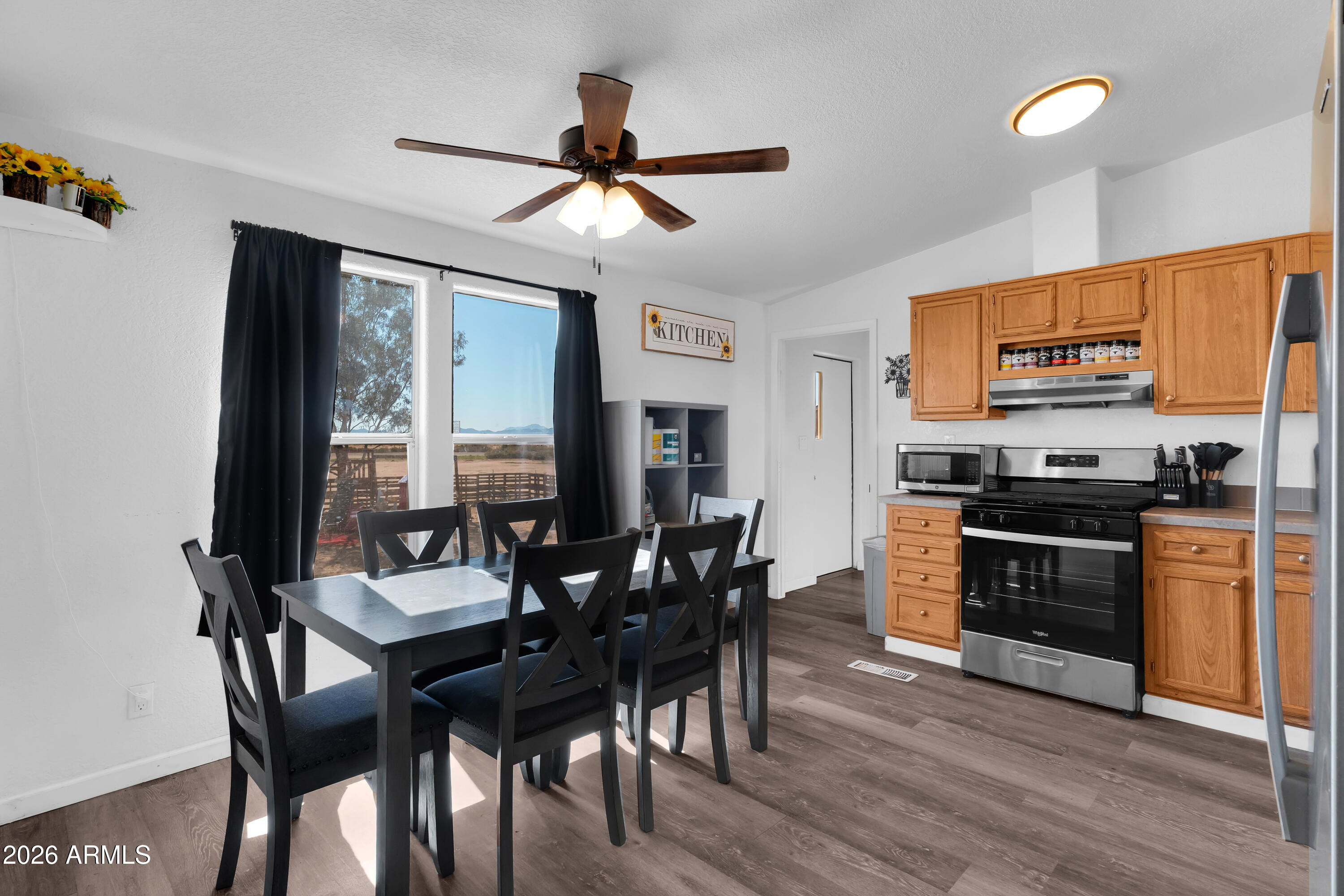 8902 Ghost Ranch Road Marana, AZ 85653 - Photo 7 of 28 a view of a dining room with furniture window and wooden floor