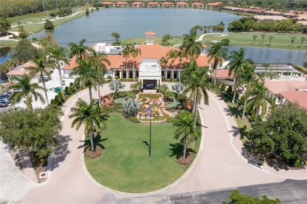 an aerial view of a house with a yard and lake view