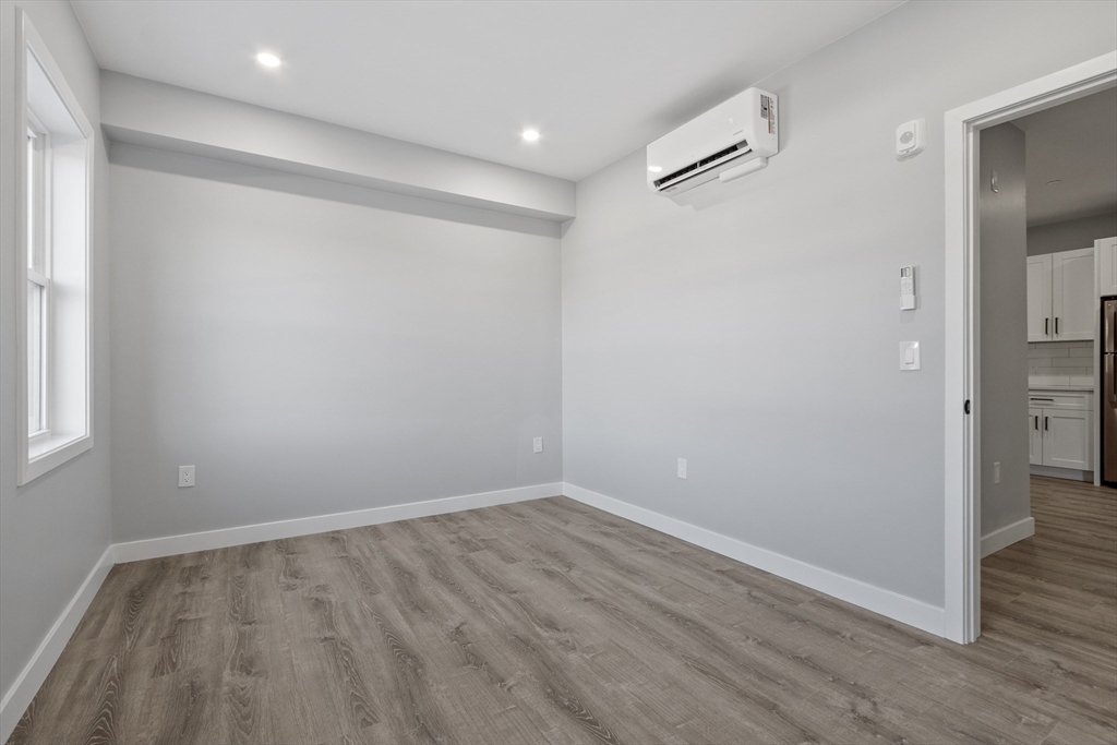 631 Franklin Street, Unit 106 Worcester, MA 01604 - Photo 12 of 36 wooden floor in an empty room with a window