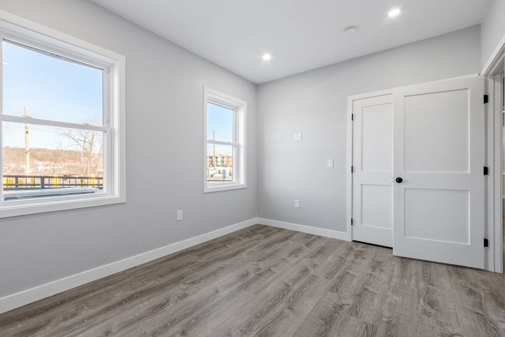 631 Franklin Street, Unit 106 Worcester, MA 01604 - Photo 16 of 36 a view of empty room with wooden floor and fan