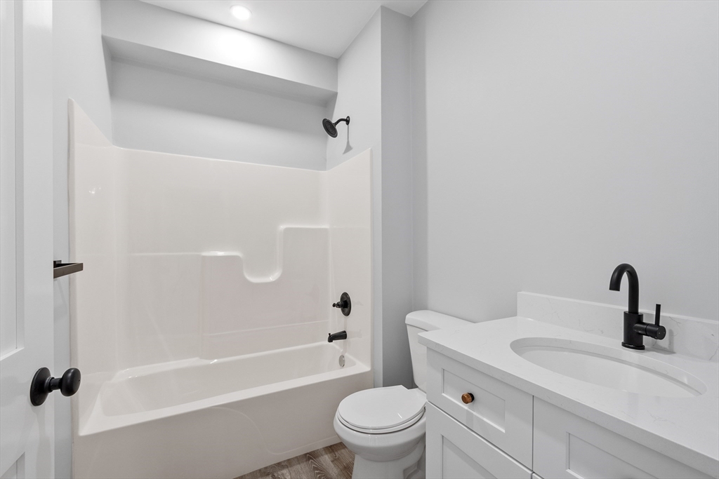 631 Franklin Street, Unit 106 Worcester, MA 01604 - Photo 18 of 36 a bathroom with a sink a toilet and a mirror
