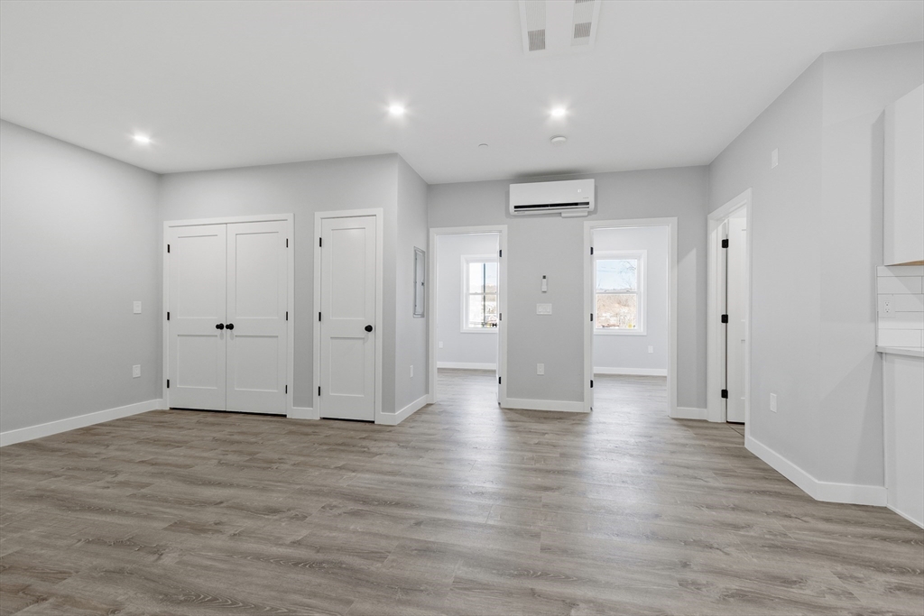 631 Franklin Street, Unit 106 Worcester, MA 01604 - Photo 5 of 36 a view of an empty room with wooden floor