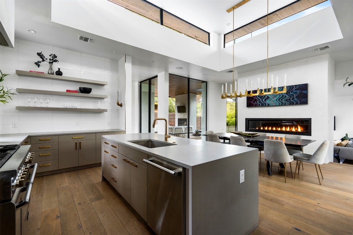 1411 Travis Heights Boulevard Austin, TX 78704 - Photo 1 of 28 a kitchen with a stove a sink and a refrigerator