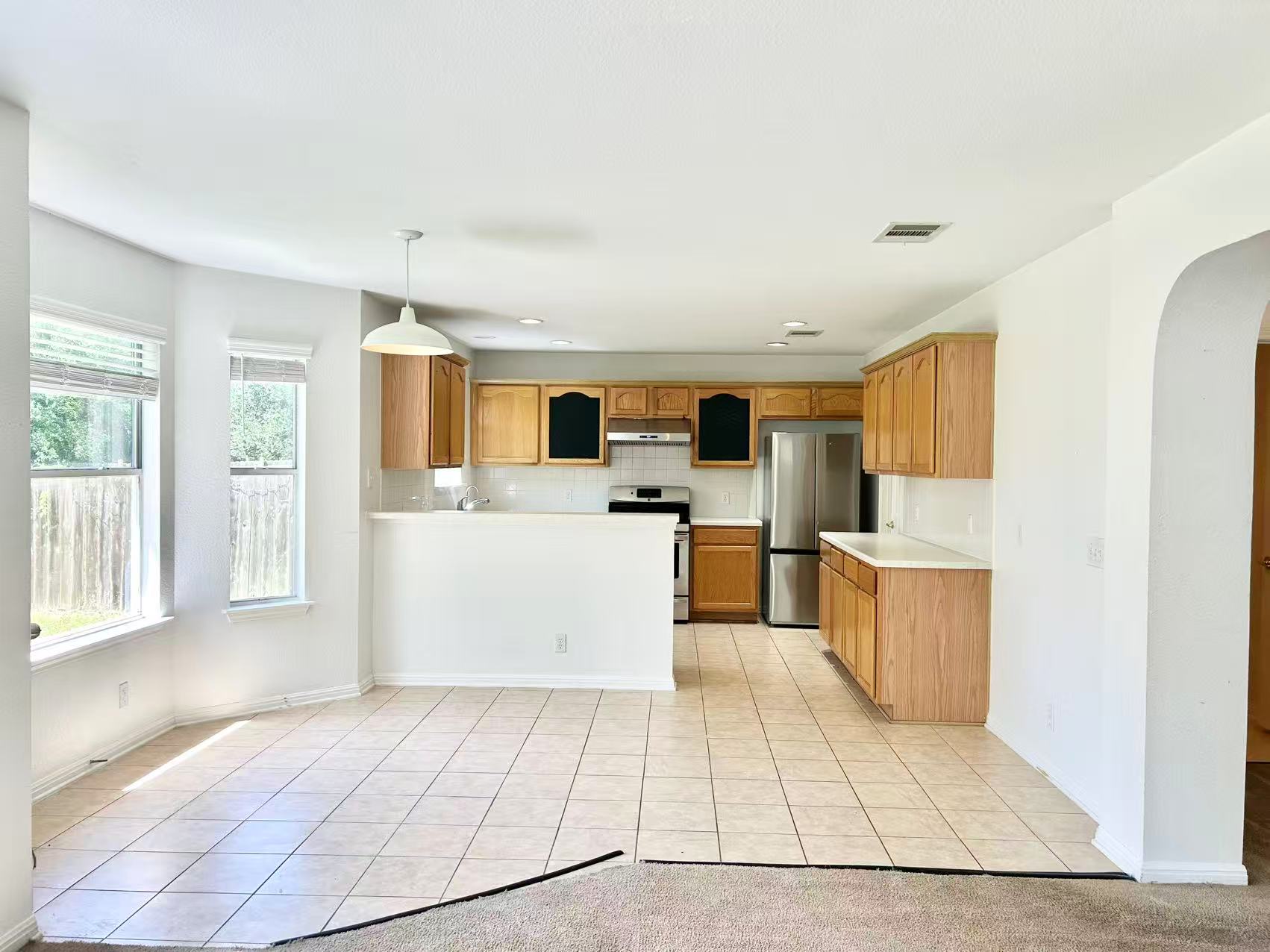5608 Netleaf Road Austin, TX 78724 - Photo 10 of 26 A well-appointed kitchen and dining area features abundant natural light and tile flooring.