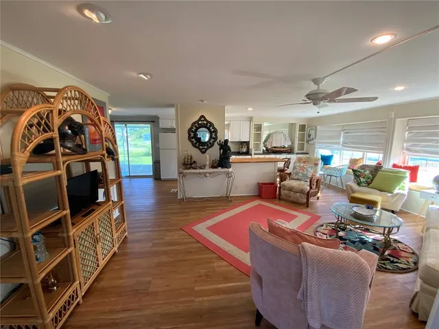 a kitchen with a wooden floor and a refrigerator