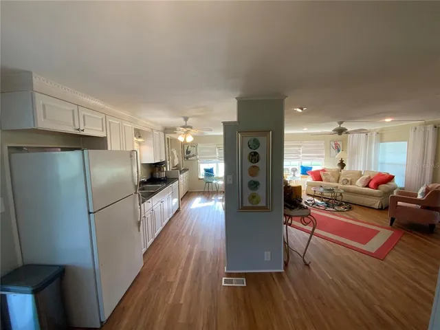 a kitchen with stainless steel appliances granite countertop a kitchen island a stove a sink cabinets and a dining table