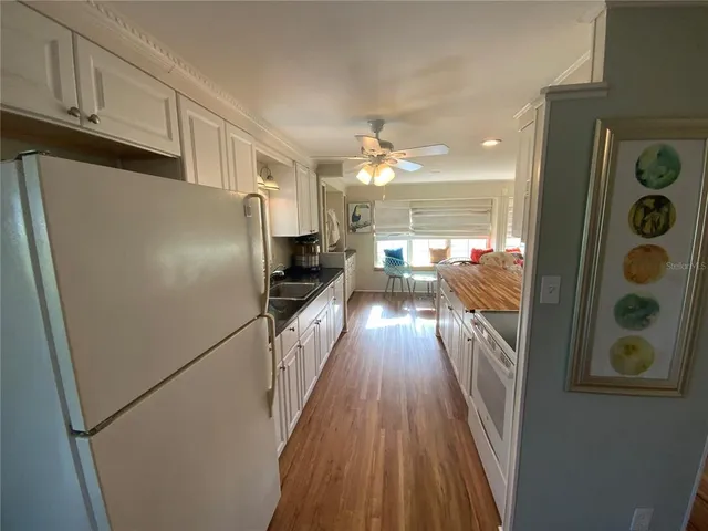 a view of a room with wooden floor furniture and a window