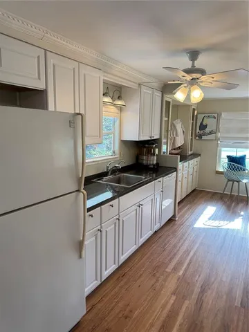a view of a livingroom with furniture and wooden floor