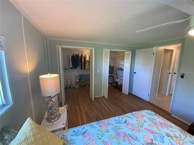 a bedroom with a large bed and a window