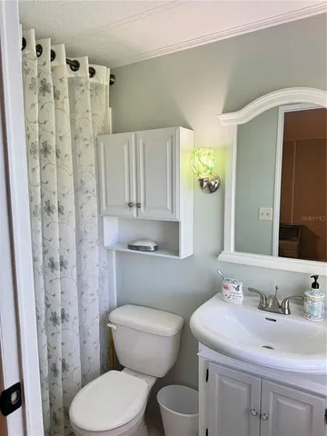 a dining room with furniture and a floor to ceiling window
