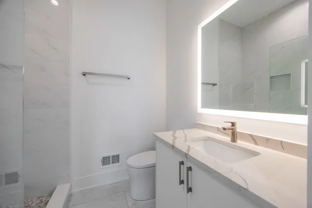 a bathroom with a sink toilet and vanity