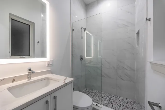 a bathroom with a sink toilet and shower