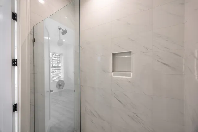 a bathroom with a glass shower door