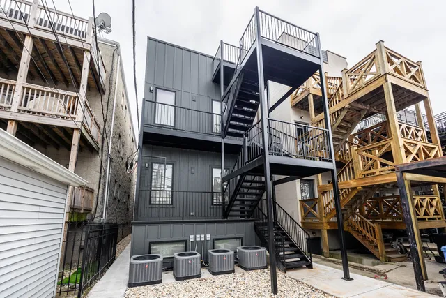 a view of a house with a small deck