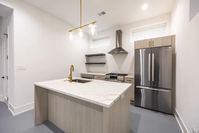 a kitchen with stainless steel appliances a refrigerator and a sink