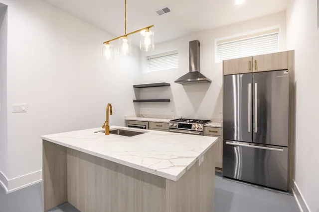 a kitchen with stainless steel appliances a refrigerator and a sink