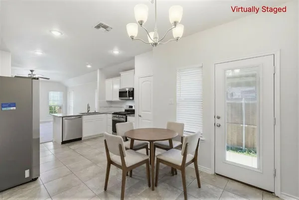 a large kitchen with a large counter top stainless steel appliances and cabinets