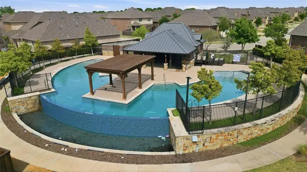 an aerial view of a house with a swimming pool yard and outdoor seating