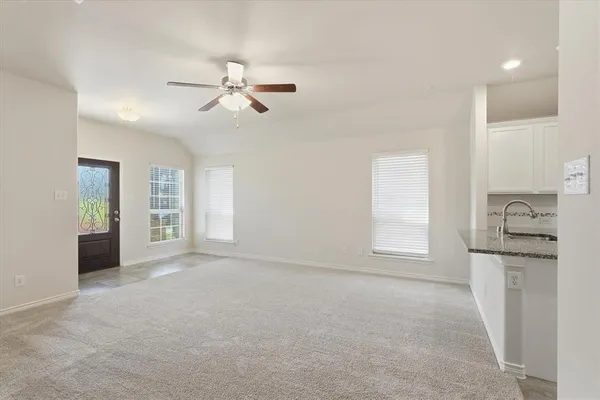 a kitchen with stainless steel appliances granite countertop a stove top oven a sink and dishwasher