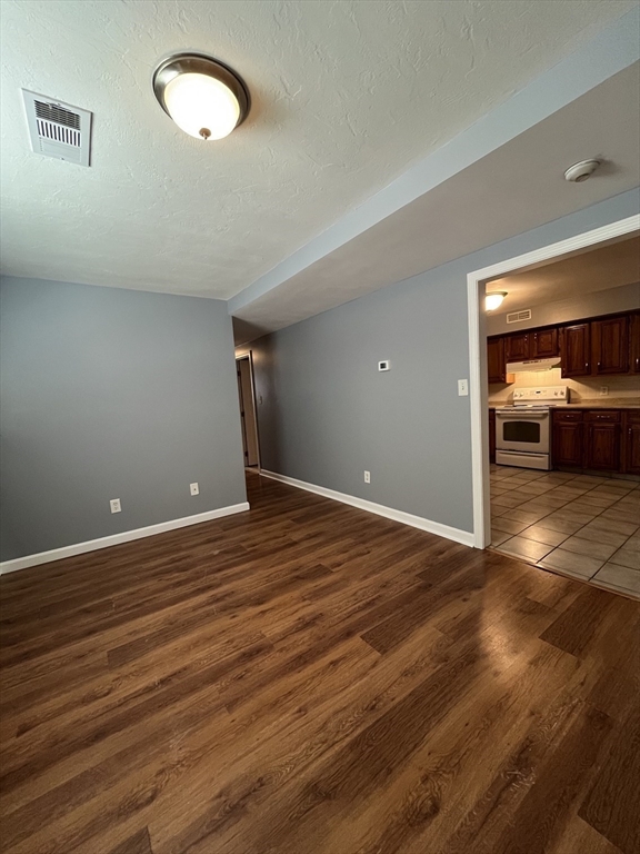 120 15th Street, Unit 4 Fall River, MA 02723 - Photo 3 of 8 a view of a room with wooden floor