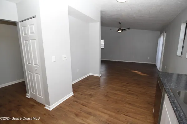 a view of a hallway with wooden floor
