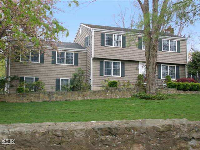 24 Golf Lane Ridgefield, CT 06877 - Photo 1 of 1 a front view of a house with a yard and garage