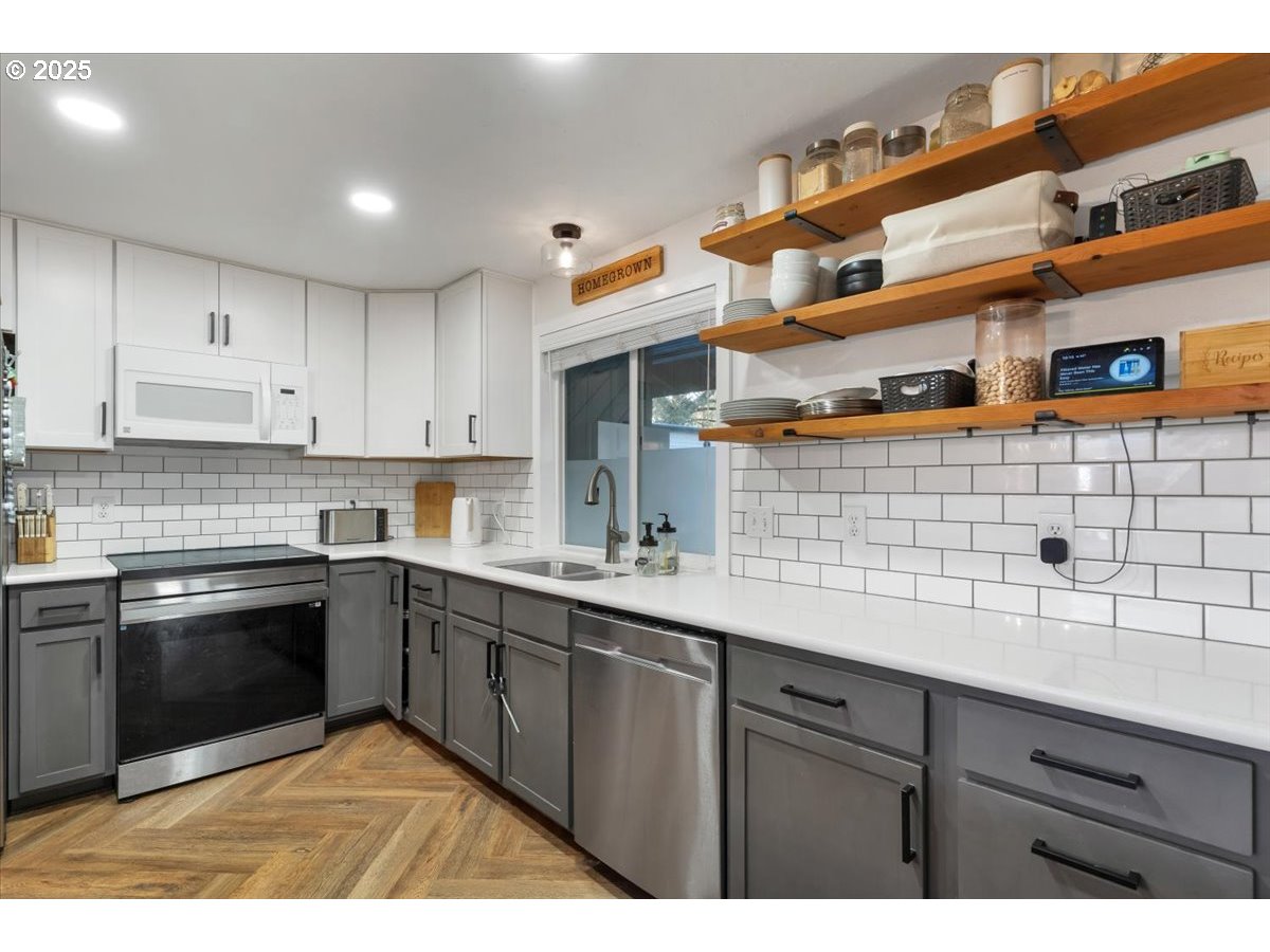 1855 Pilgrim Street Southeast Salem, OR 97302 - Photo 12 of 48 a kitchen with stainless steel appliances granite countertop a sink and cabinets