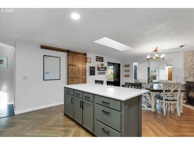 a view of living room with granite countertop furniture and wooden floor