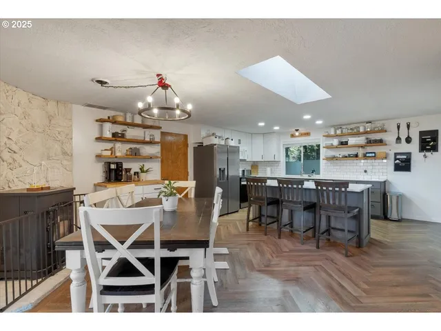 a dining room with furniture and wooden floor