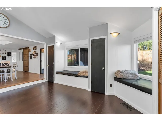 a hallway with wooden floor and furniture